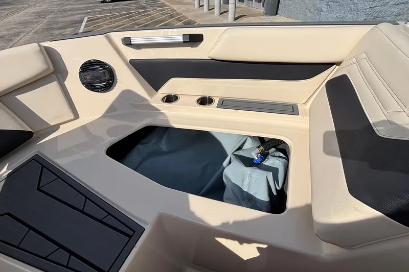 Slide: The Image of Interior view of 2026 ATX Surf Boats 24 Type-S, featuring storage compartment and seating. - 42