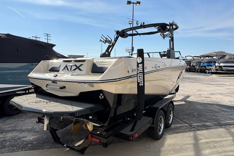 Slide: The Image of 2026 ATX Surf Boats 24 Type-S on trailer in a boat dealership lot. - 8
