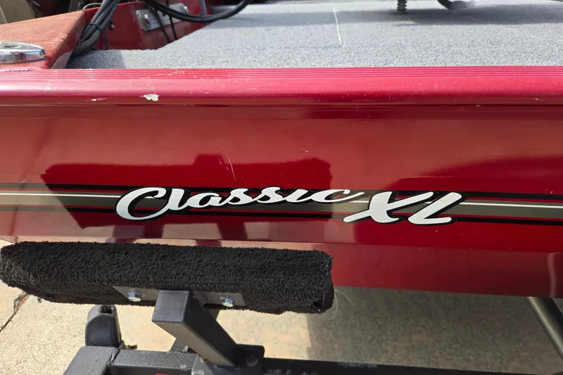 Slide: The Image of 2022 Tracker Bass Tracker Classic XL boat, red exterior with "Classic XL" logo. - 12