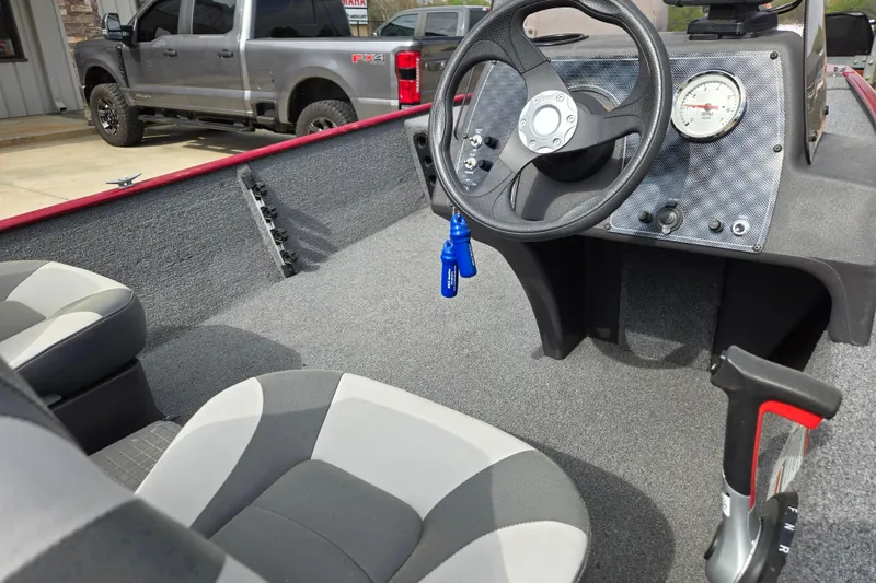 Slide: The Image of 2022 Tracker Bass Tracker Classic XL boat interior with steering wheel and seats. - 13