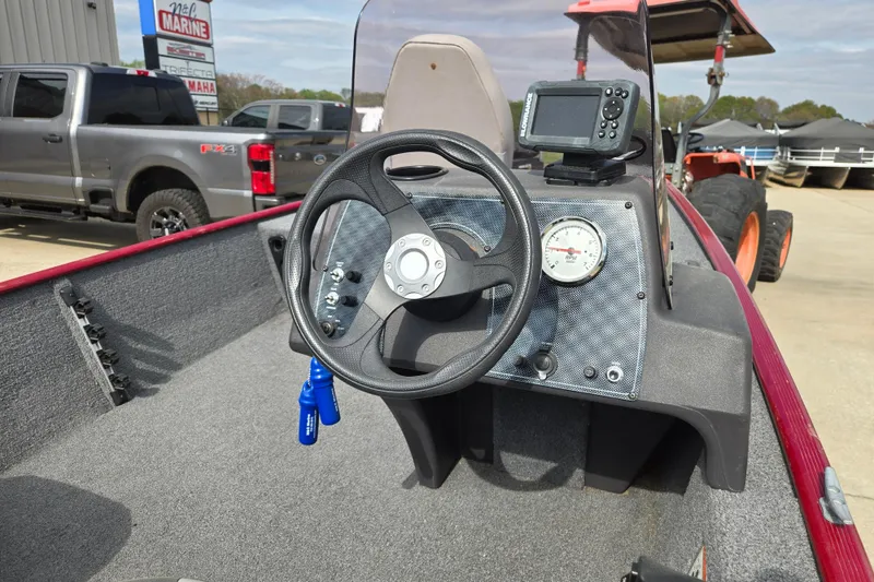 Slide: The Image of 2022 Tracker Bass Tracker Classic XL boat dashboard with steering wheel and fish finder. - 7