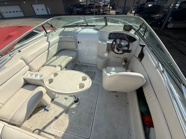 Slide: The Image of Interior of a 2001 Crownline 230 CCR boat with steering wheel and seating area. - 3