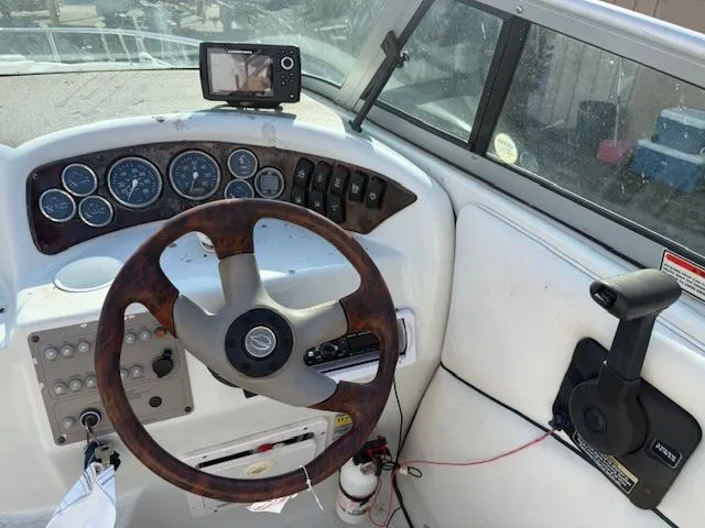 Slide: The Image of Dashboard of a 2001 Crownline 230 CCR boat with wooden steering wheel. - 4