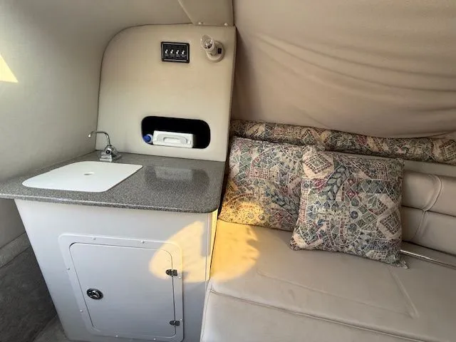 Slide: The Image of Interior of 2001 Crownline 230 CCR with sink and seating area. - 6