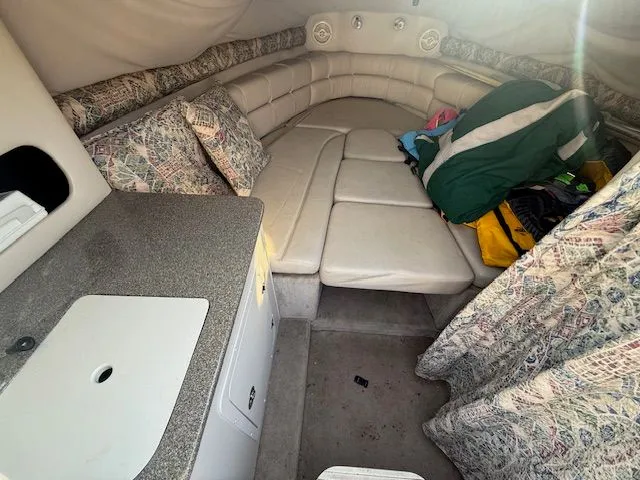 Slide: The Image of Interior of a 2001 Crownline 230 CCR boat with seating area and kitchenette. - 7