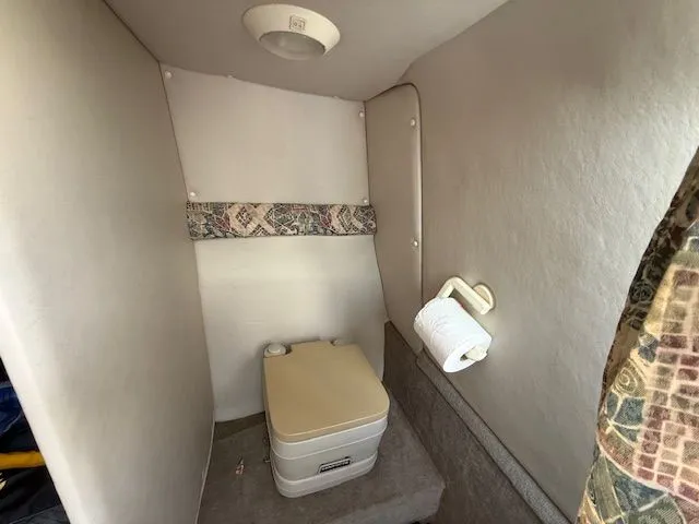 Slide: The Image of Interior of a 2001 Crownline 230 CCR with portable toilet. - 8