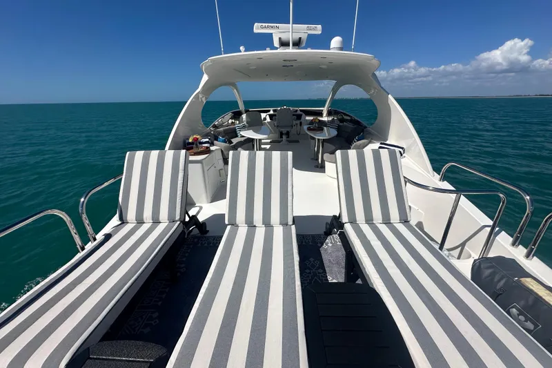 Slide: The Image of Luxurious 2006 Lazzara 68 Motoryacht with striped sun loungers on open sea. - 16