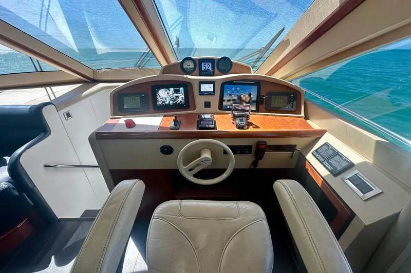 Slide: The Image of Helm of 2006 Lazzara 68 Motoryacht with navigation screens and controls, overlooking the ocean. - 36