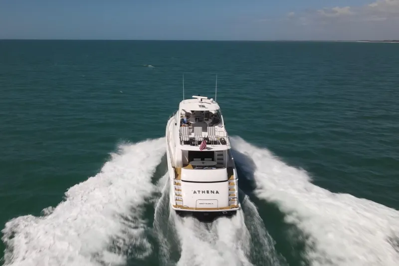 Slide: The Image of 2006 Lazzara 68 Motoryacht cruising on open sea, rear view. - 4