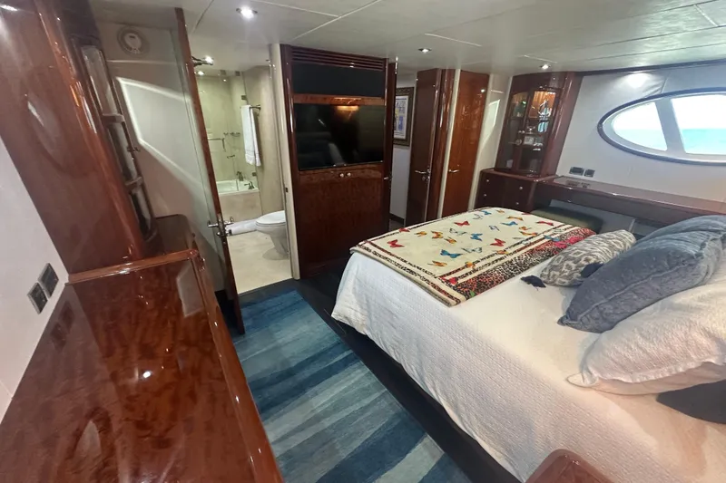 Slide: The Image of Luxurious 2006 Lazzara 68 Motoryacht bedroom with elegant wood finishes and modern amenities. - 59
