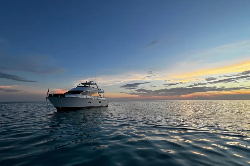Slide: The Image of Lazzara 68 Motoryacht 2006 at sunset on calm ocean waters. - 6