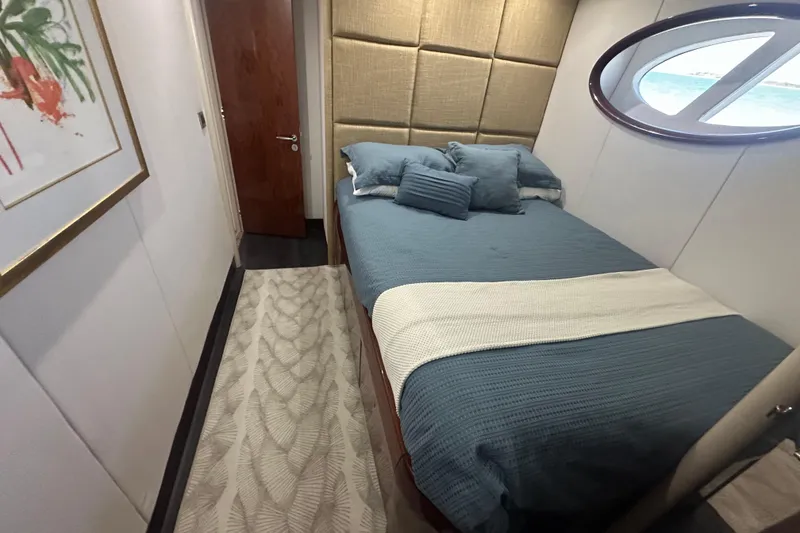 Slide: The Image of Luxurious bedroom interior of 2006 Lazzara 68 Motoryacht with blue bedding and porthole window. - 61