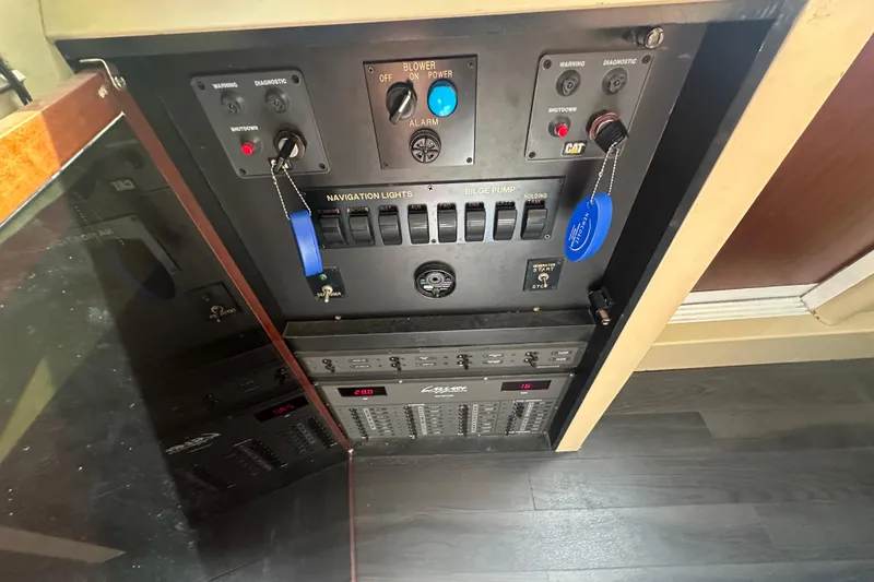 Slide: The Image of Control panel of a 2006 Lazzara 68 Motoryacht, featuring navigation and bilge pump switches. - 67