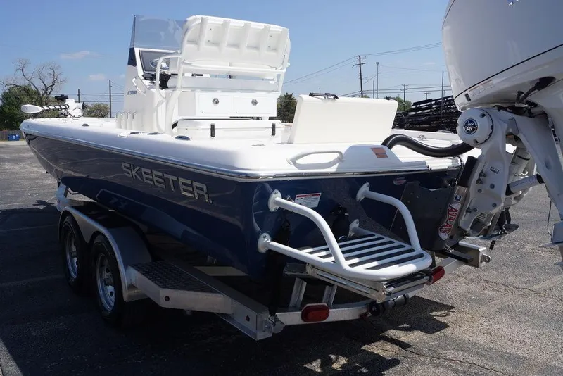 Slide: The Image of 2026 Skeeter SX241 boat on trailer, rear view with motor and ladder. - 14