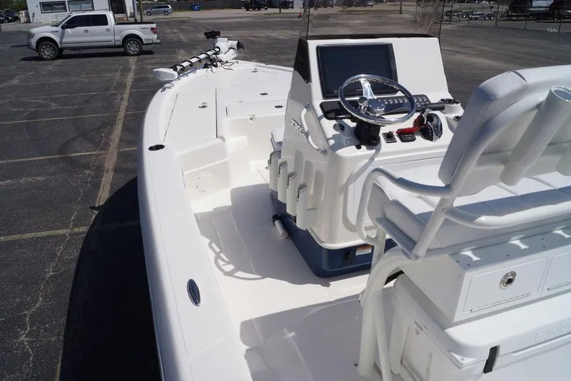 Slide: The Image of 2026 Skeeter SX241 boat with modern console and seating in a parking lot. - 16
