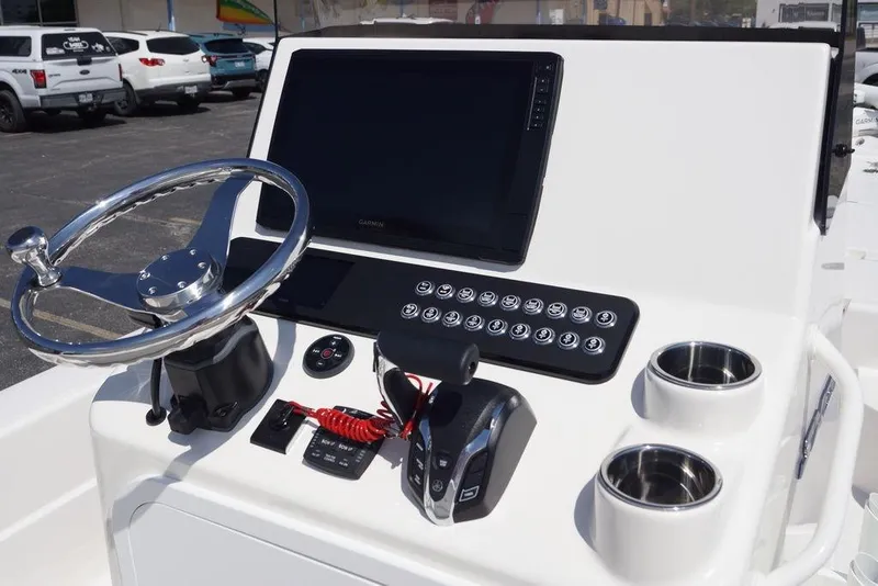 Slide: The Image of 2026 Skeeter SX241 boat dashboard with steering wheel, control panel, and cup holders. - 21