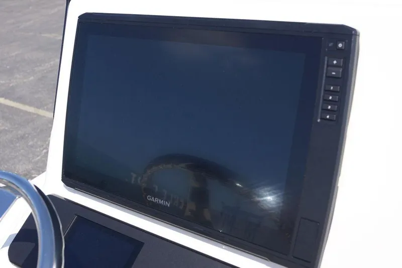 Slide: The Image of Garmin display on 2026 Skeeter SX241 boat dashboard, featuring control buttons. - 26