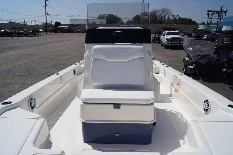 Slide: The Image of 2026 Skeeter SX241 boat interior with seating and console, parked outdoors. - 29