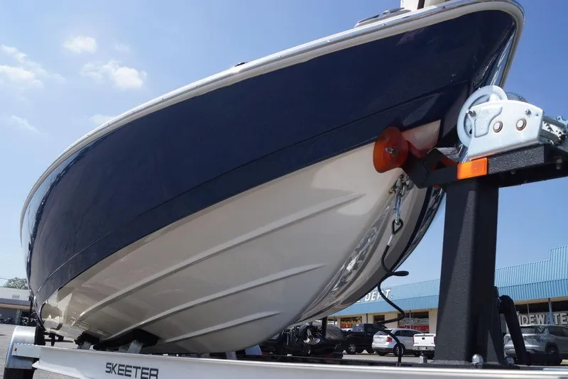 Slide: The Image of 2026 Skeeter SX241 boat on trailer, viewed from below, showcasing sleek hull design. - 6