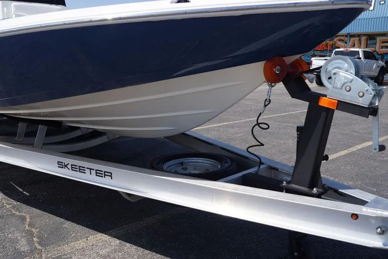 Slide: The Image of 2026 Skeeter SX241 boat on trailer, showcasing hull and winch system. - 8