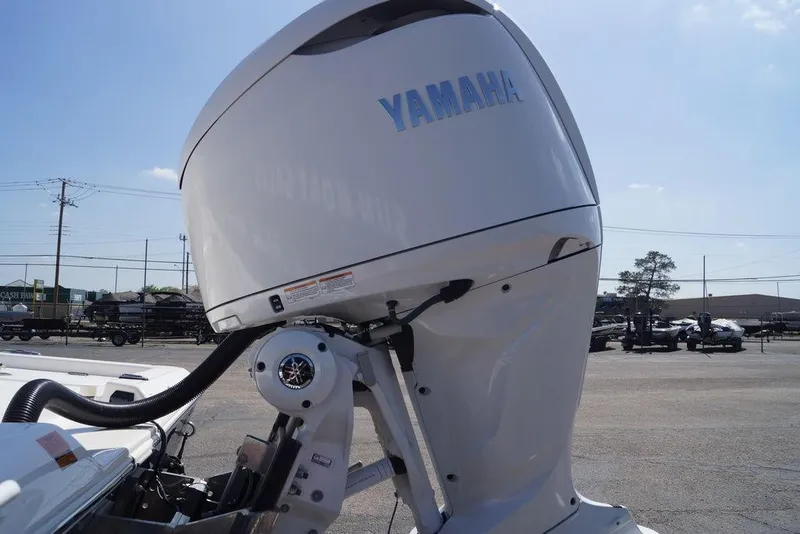 Slide: The Image of 2026 Skeeter SX241 boat with Yamaha outboard motor in a parking lot. - 9