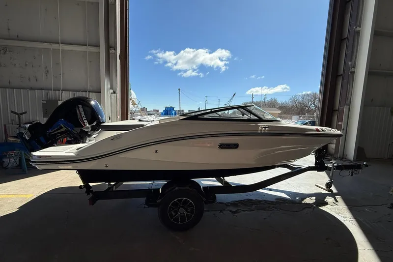 Slide: The Image of 2025 Sea Ray 19 SPX OB boat on trailer in a warehouse setting. - 1