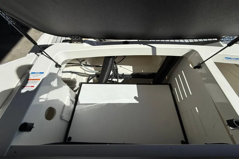 Slide: The Image of Open engine compartment of 2025 Sea Ray 19 SPX OB boat, showcasing interior components. - 12