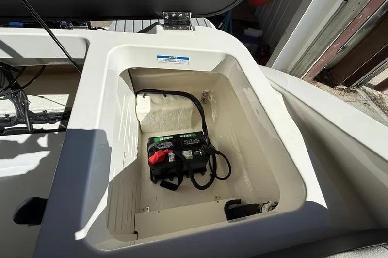 Slide: The Image of Battery compartment of 2025 Sea Ray 19 SPX OB boat, showing wiring and connections. - 13