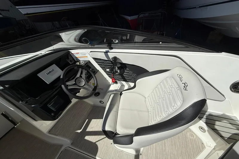 Slide: The Image of Interior view of 2025 Sea Ray 19 SPX OB boat cockpit with steering wheel and seat. - 16