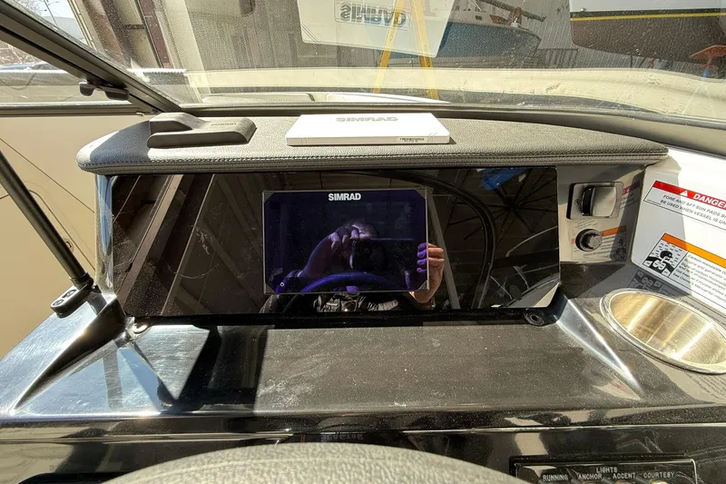Slide: The Image of Dashboard of 2025 Sea Ray 19 SPX OB with Simrad display and controls. - 17
