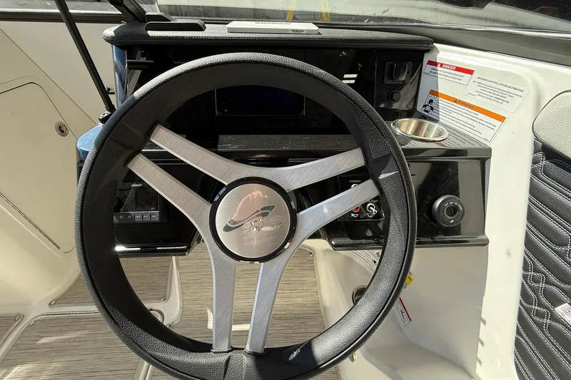 Slide: The Image of Steering wheel of 2025 Sea Ray 19 SPX OB boat, featuring modern dashboard controls. - 18