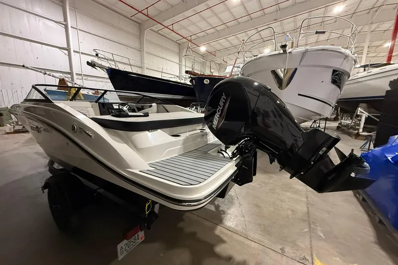 Slide: The Image of 2025 Sea Ray 19 SPX OB boat with Mercury outboard in a storage facility. - 2