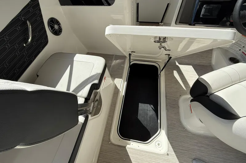 Slide: The Image of 2025 Sea Ray 19 SPX OB boat interior with open storage compartment and seating. - 21