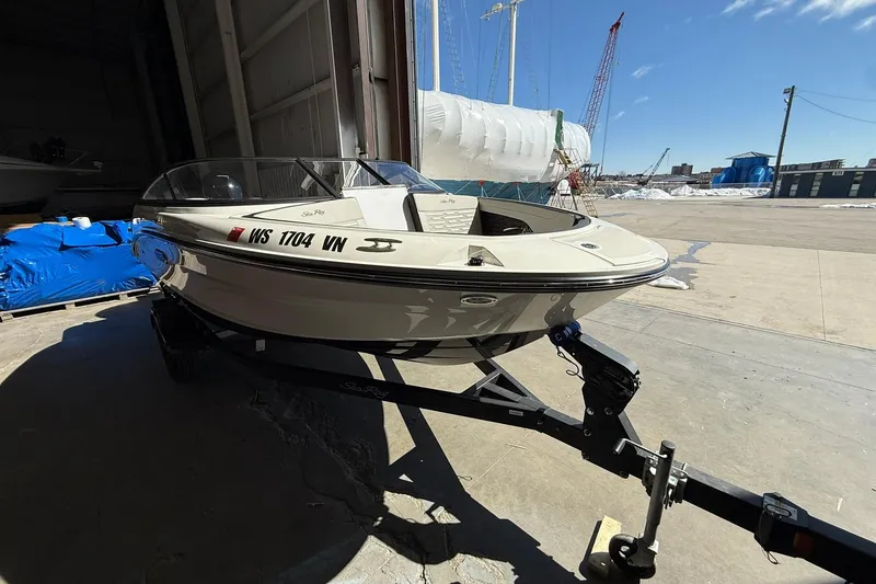 Slide: The Image of 2025 Sea Ray 19 SPX OB boat on trailer in a marina setting. - 3