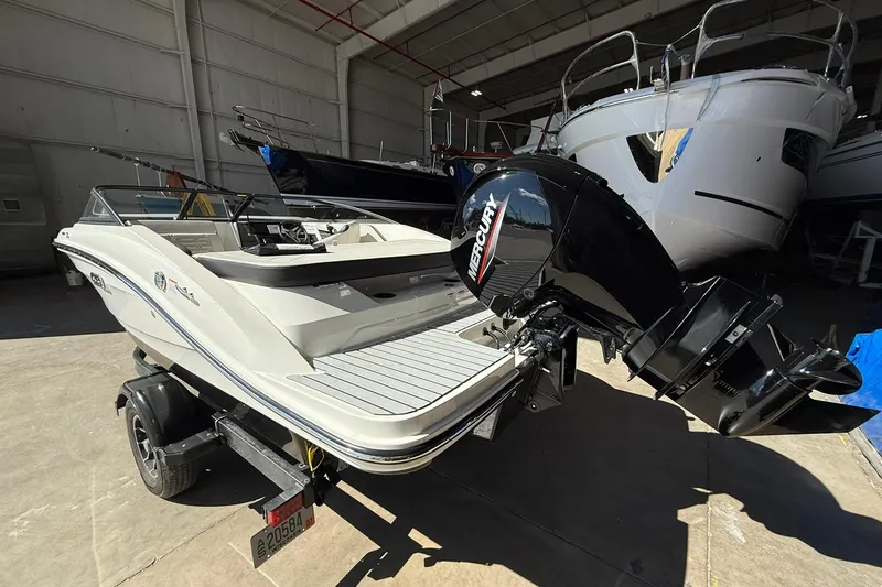 Slide: The Image of 2025 Sea Ray 19 SPX OB boat with Mercury outboard engine in a storage facility. - 4