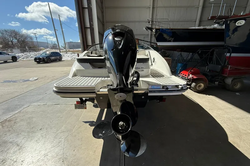 Slide: The Image of 2025 Sea Ray 19 SPX OB boat in a garage, rear view with outboard motor. - 5