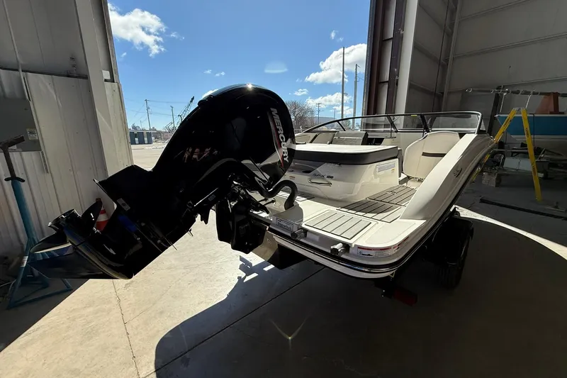 Slide: The Image of 2025 Sea Ray 19 SPX OB boat with outboard motor in a sunlit garage. - 7