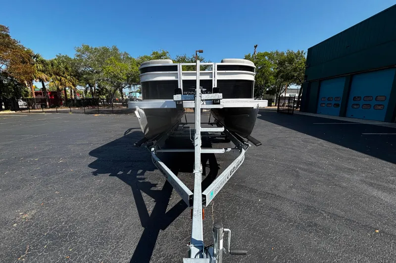 Slide: The Image of 2023 Bennington 188SLJ pontoon boat on trailer in parking lot. - 3
