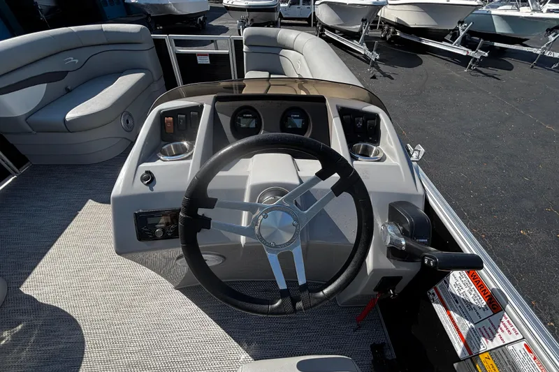 Slide: The Image of 2023 Bennington 188SLJ boat dashboard with steering wheel and controls. - 6