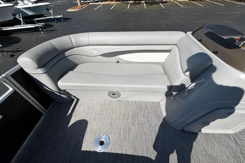 Slide: The Image of 2023 Bennington 188SLJ pontoon boat interior with gray seating and carpeted floor. - 8