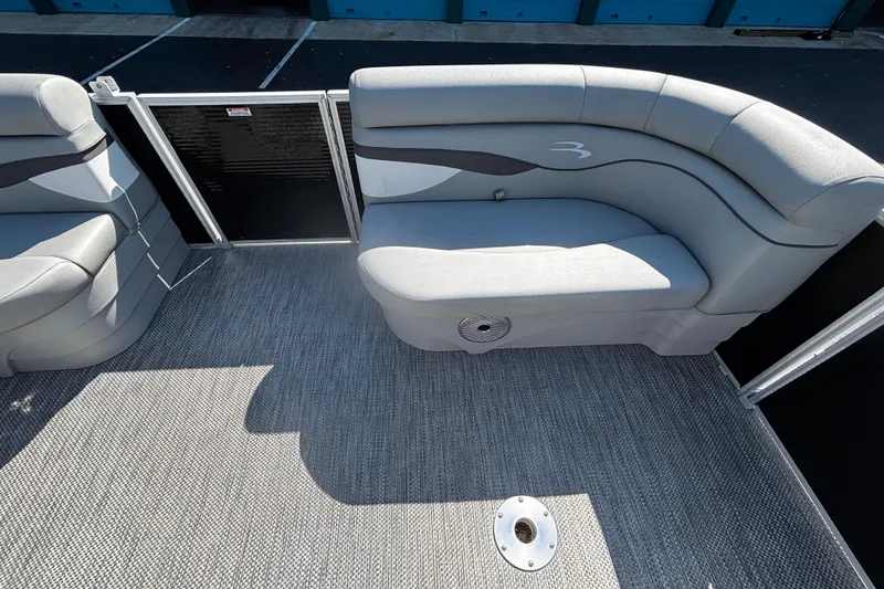 Slide: The Image of 2023 Bennington 188SLJ pontoon boat interior with gray seating and carpeted flooring. - 9