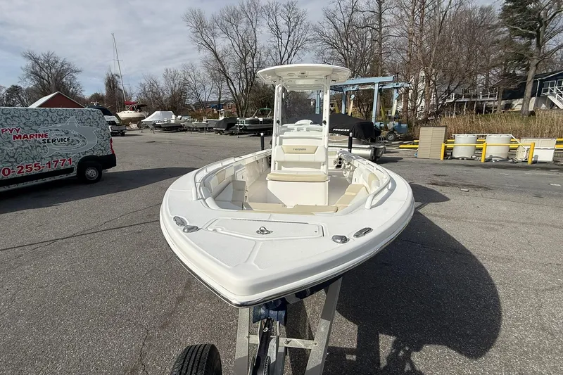 Slide: The Image of 2016 Everglades 243 Center Console boat on display in a marina parking lot. - 10