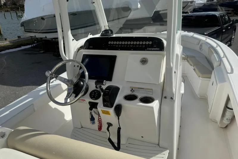 Slide: The Image of 2016 Everglades 243 Center Console boat interior with steering wheel and control panel. - 14