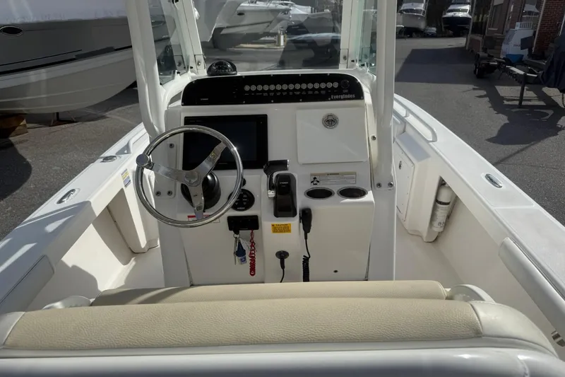 Slide: The Image of 2016 Everglades 243 Center Console boat interior with steering wheel and controls. - 15