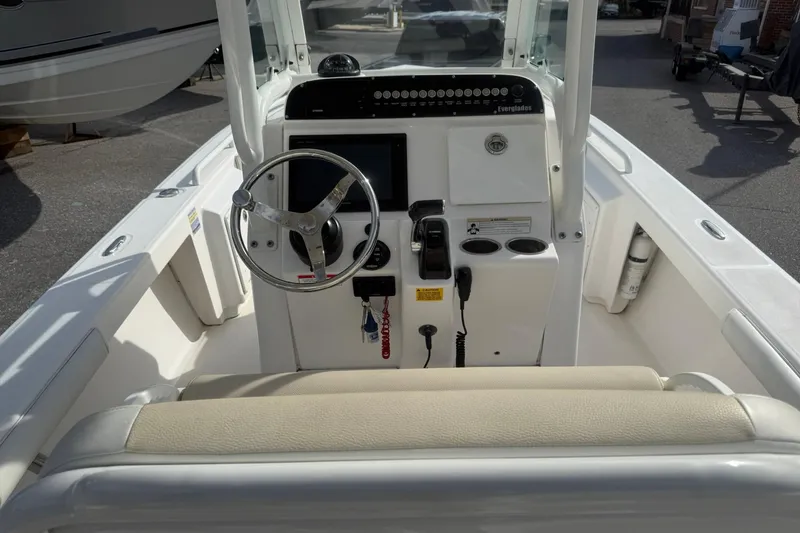 Slide: The Image of 2016 Everglades 243 Center Console boat interior with steering wheel and control panel. - 16