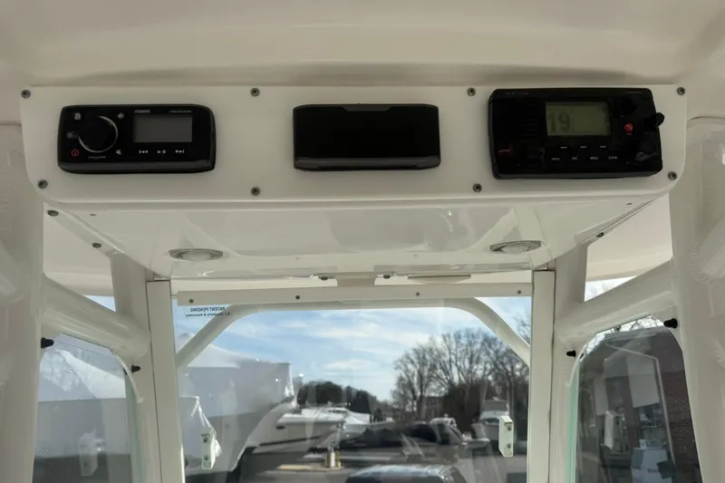 Slide: The Image of 2016 Everglades 243 Center Console boat dashboard with radio and navigation equipment. - 19
