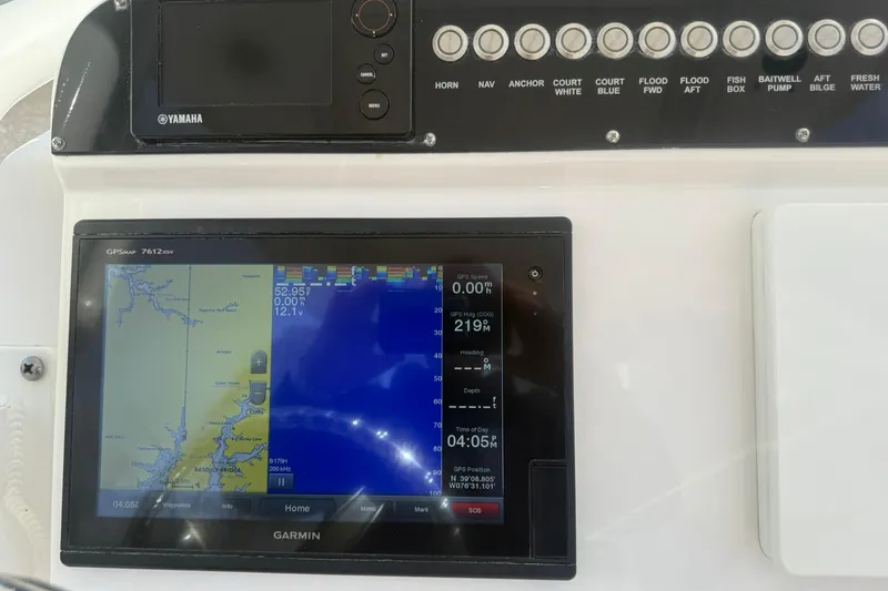 Slide: The Image of 2016 Everglades 243 Center Console dashboard with Garmin GPS and Yamaha controls. - 25
