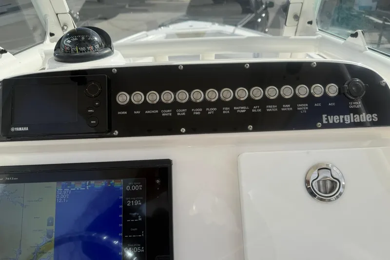 Slide: The Image of Control panel of a 2016 Everglades 243 Center Console boat with navigation instruments. - 26