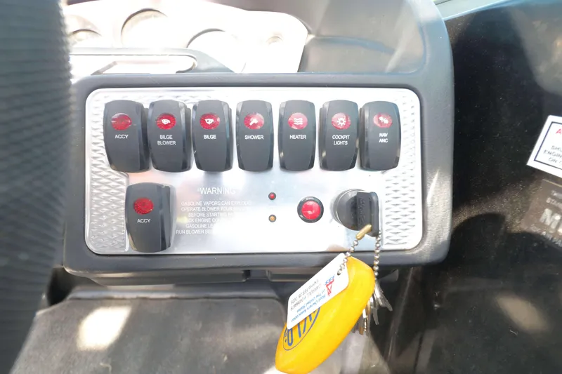 Slide: The Image of Control panel of 2012 MB B-52 23 Widebody boat with labeled switches and keys. - 15
