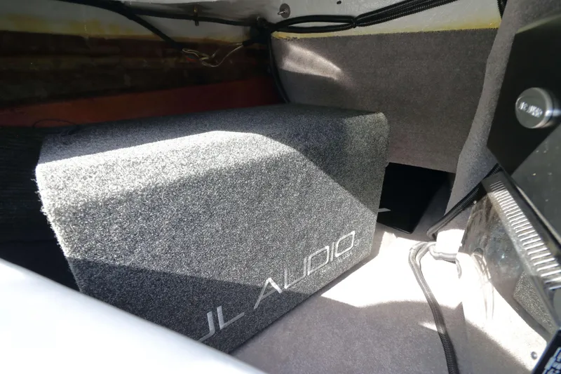 Slide: The Image of JL Audio subwoofer installed in a 2012 MB B-52 23 Widebody boat interior. - 16